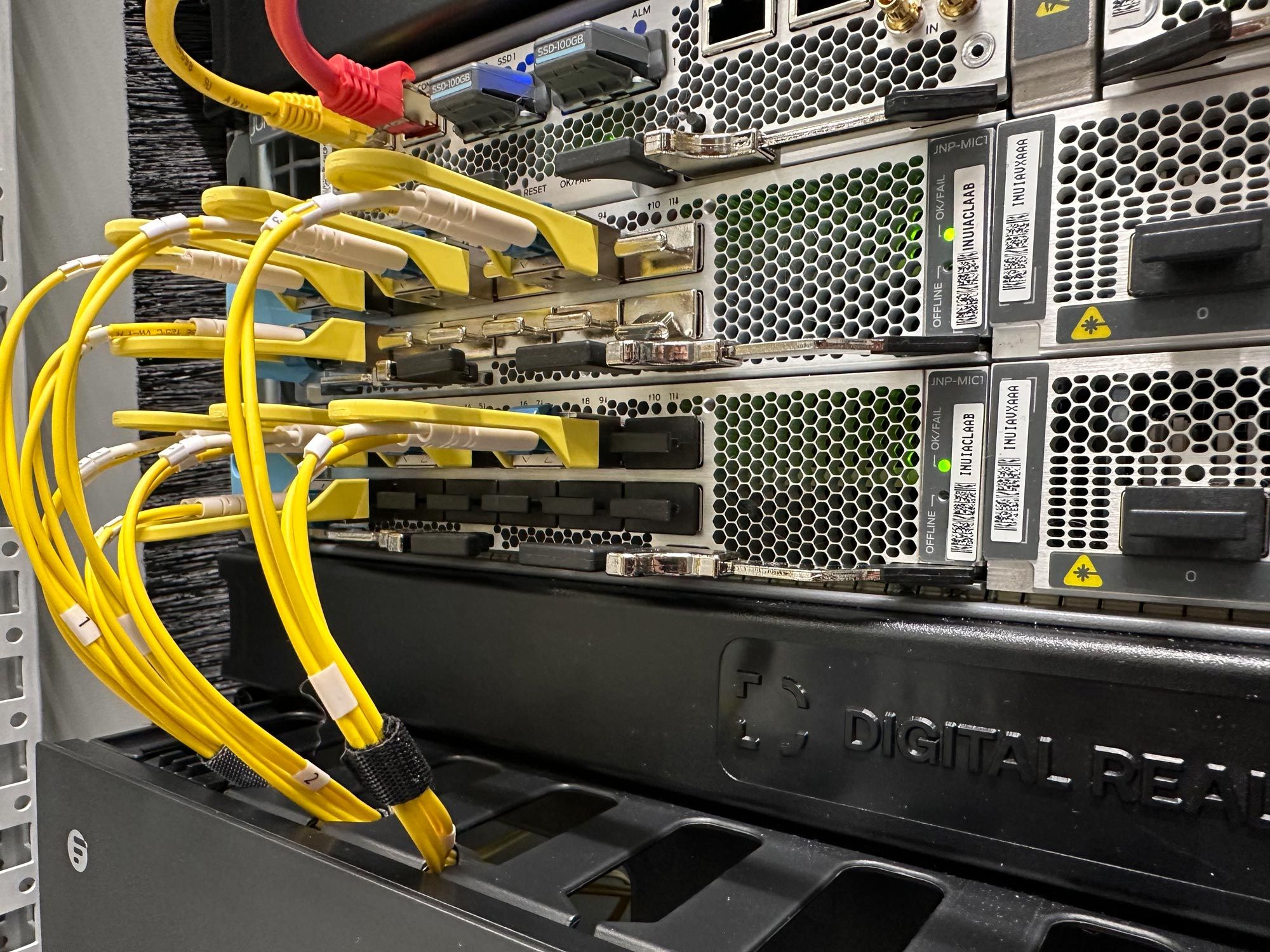 Close-up of yellow and red ethernet cables connected to network hardware in a data center